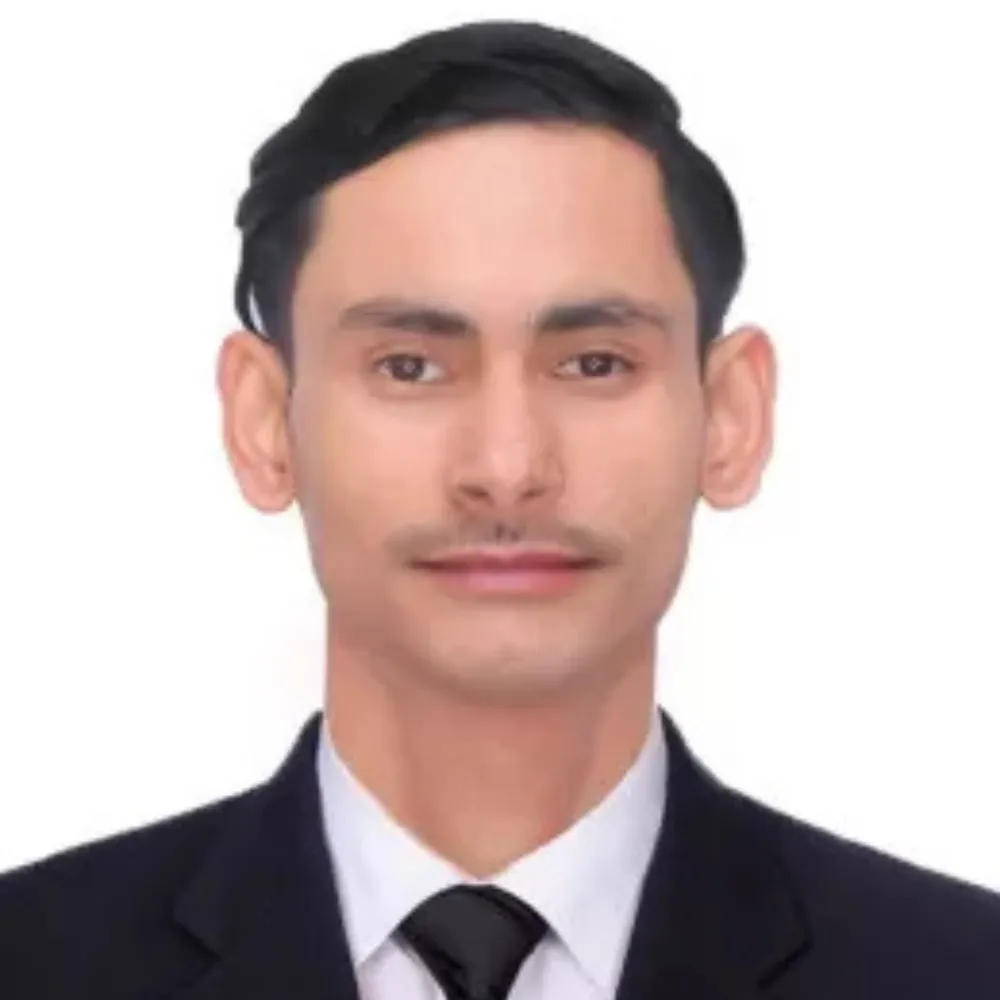 Portrait of a man in a formal suit and tie, set against a plain white background. He appears confident and composed, with short dark hair.
