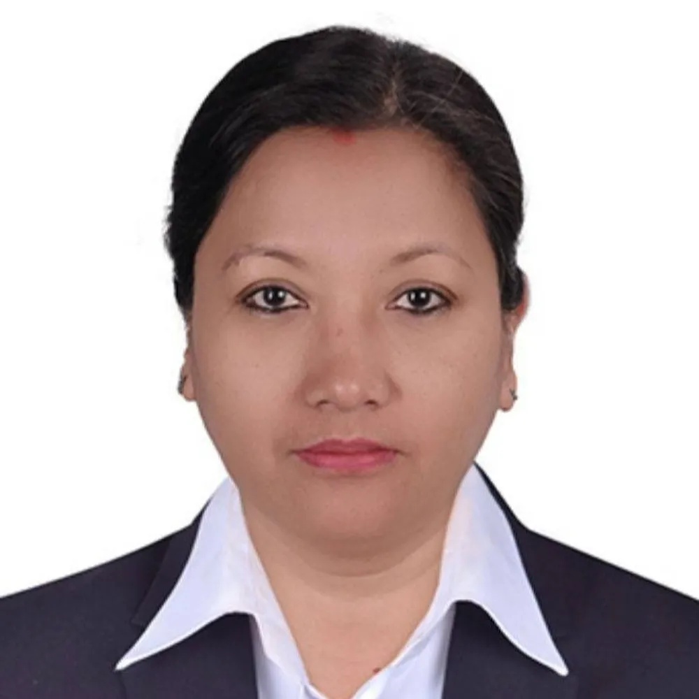 A woman in a formal suit with a white shirt stares directly at the camera against a plain white background, conveying a neutral expression.